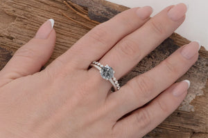 wedding ring and engagement ring set on hand